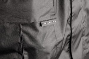 Photo showing jacket pocket tab on Solo Storm Jacket in Black on white background